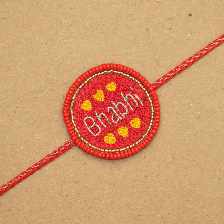 Handmade Beaded Bhabhi Rakhi With Roli Chawal - Flat Lay Close-up View