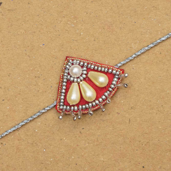 Handmade Beaded Paw Silver Rakhi With Roli Chawal - Close-up of Rakhi thread detail