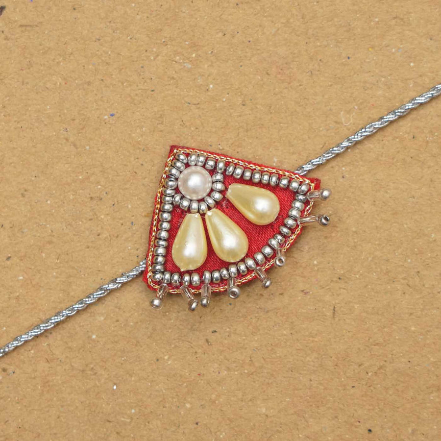 Handmade Beaded Paw Silver Rakhi With Roli Chawal - Close-up of Rakhi thread detail