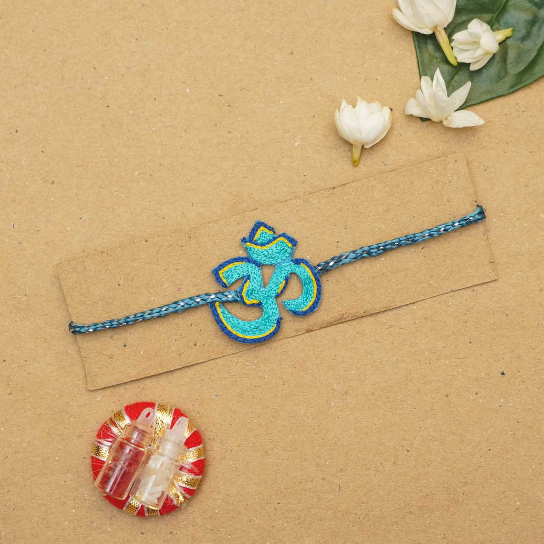 Handmade Beaded Om Rakhi With Roli Chawal - Packaged on card blue variant