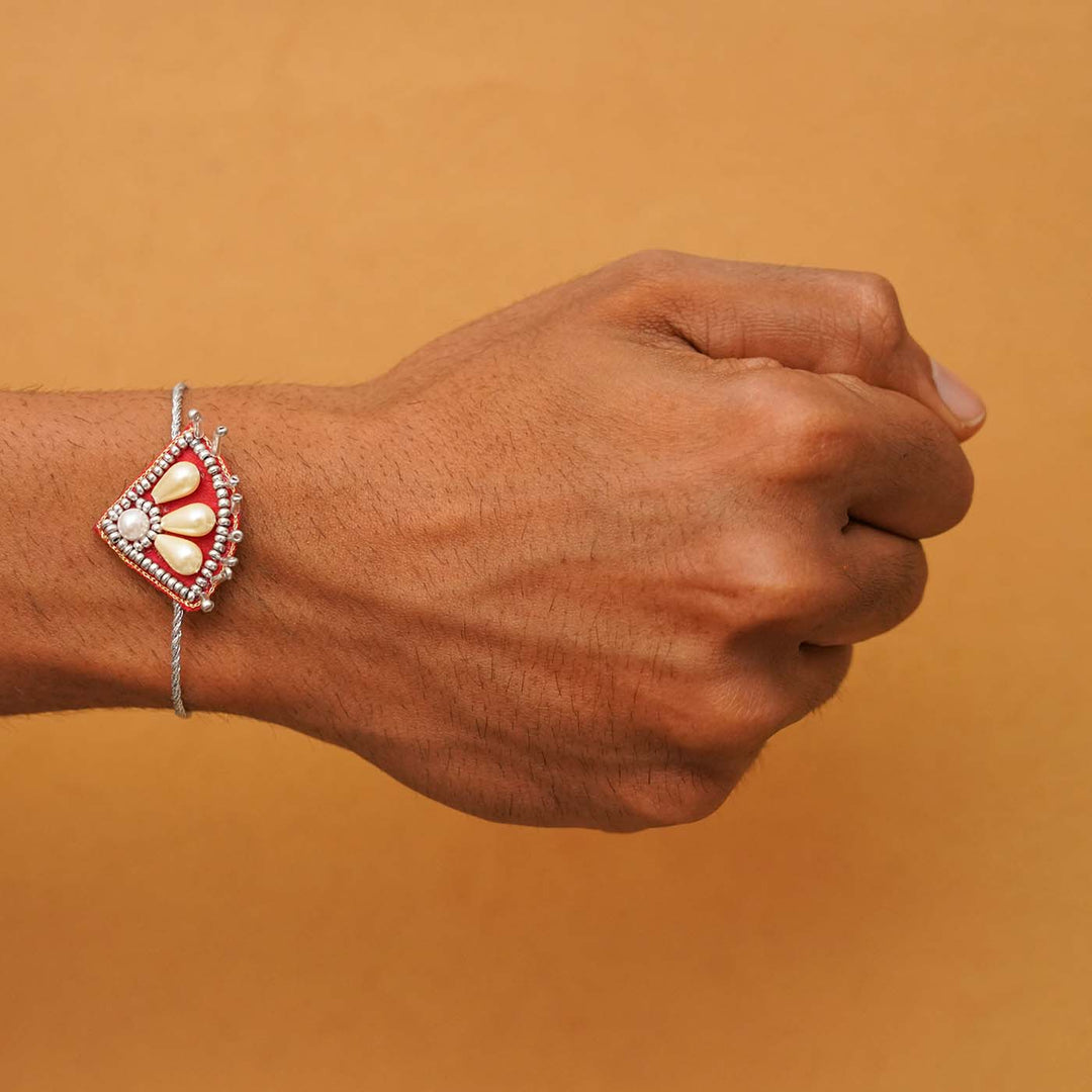 Handmade Beaded Paw Silver Rakhi With Roli Chawal - Rakhi worn on wrist model