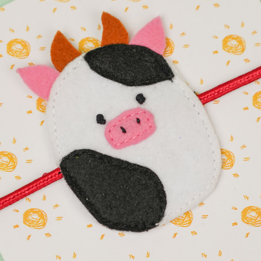 Handmade Squish Mallows Cow Theme Felt Kids Rakhi - Close-up of Cow Design