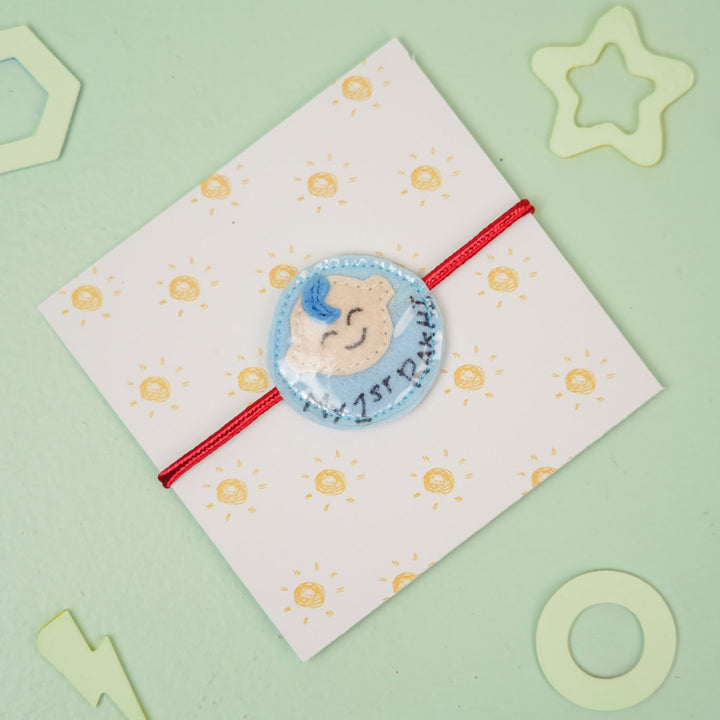 Handmade Baby Boy Theme Felt Kids Rakhi For Brother - Angled view on card background