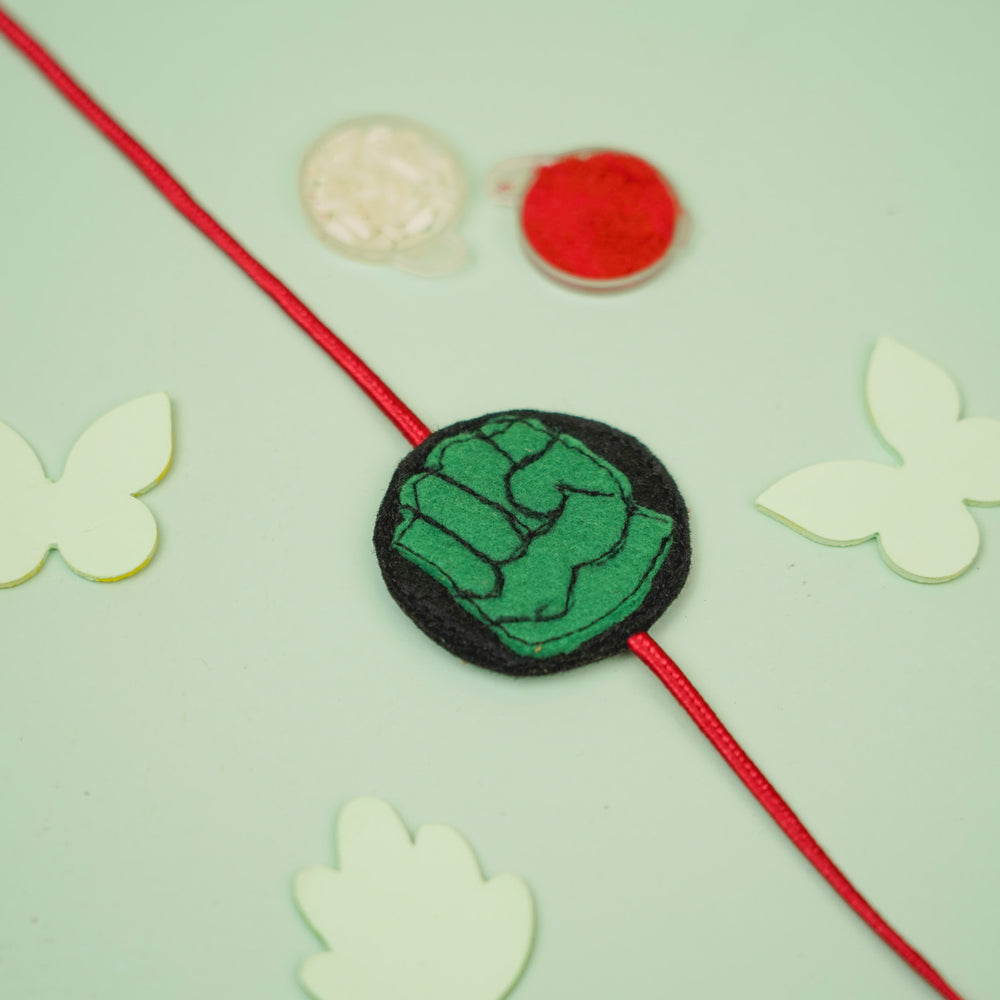 Handmade Hulk Theme Felt Kids Rakhi For Brother - Flat Lay with Decorative Background
