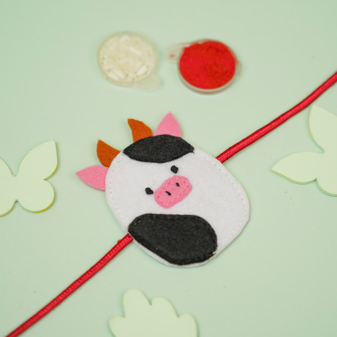 Handmade Squish Mallows Cow Theme Felt Kids Rakhi - Styled Product with Decorative Elements