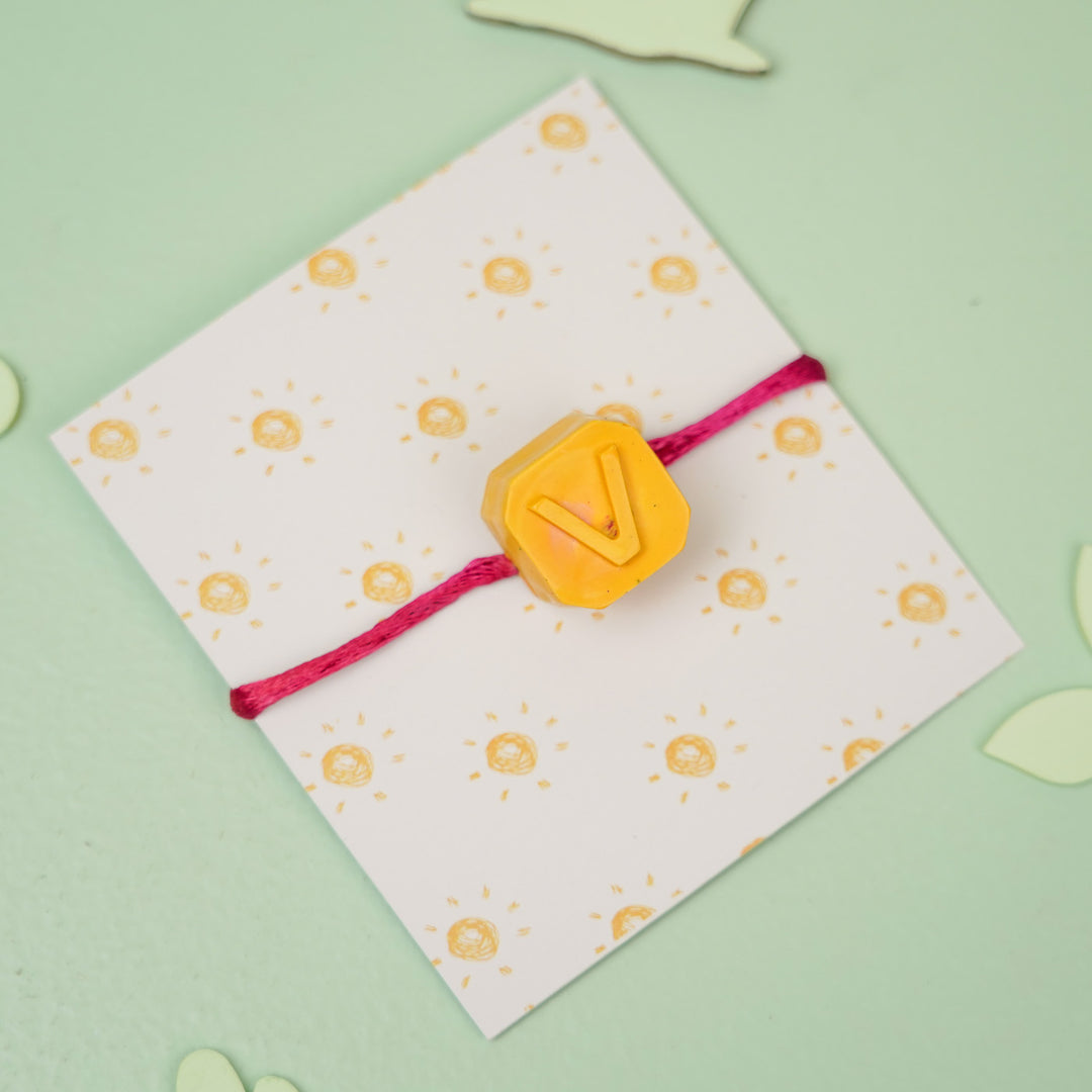 Personalized Handmade Mini Letters Wax Rakhi For Kids - Full product view with "V" charm