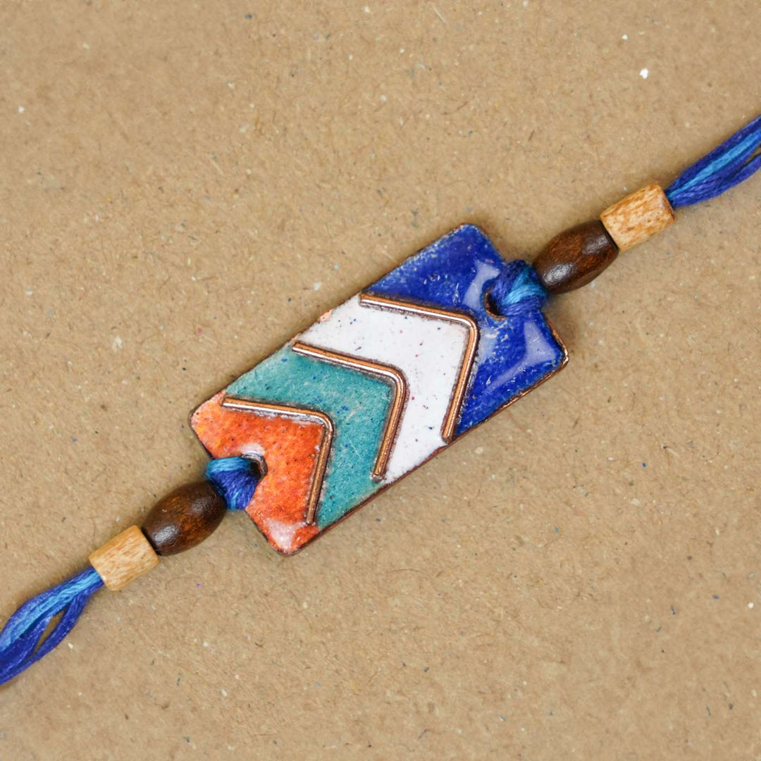 Handmade Arrows Copper Enamel Rakhi With Chocolates And Roli Chawal - Close-up of Bracelet Design