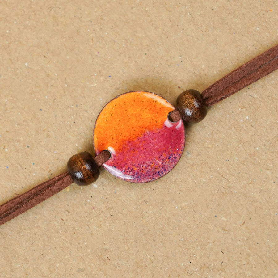 Handmade Ambar Yellow Copper Enamel Rakhi With Chocolates And Roli Chawal - Close-up of single bracelet detail