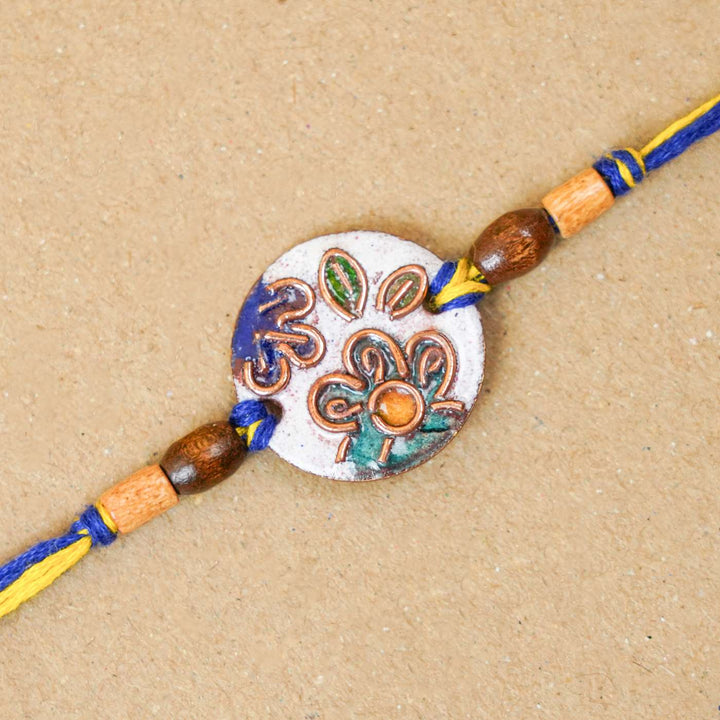 Handmade Phool White Copper Enamel Rakhi With Chocolates And Roli Chawal - Close-up of Rakhi thread detail