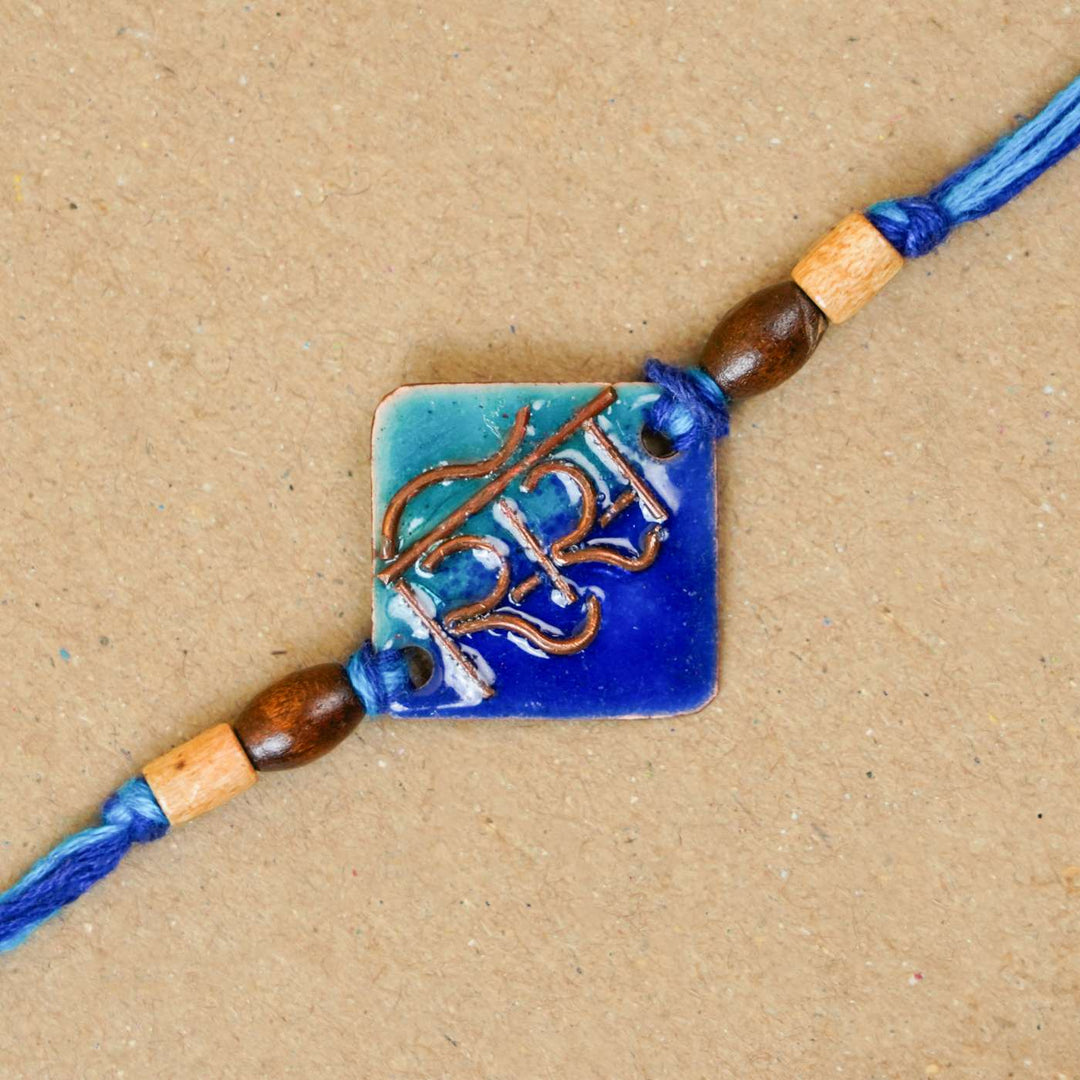 Handmade Sis Blue Copper Enamel Rakhi With Chocolates And Roli Chawal - Close-up of single Rakhi bead