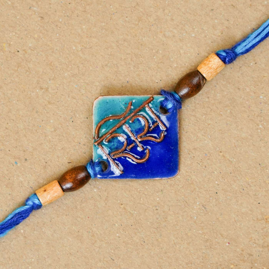 Handmade Sis Blue Copper Enamel Rakhi With Chocolates And Roli Chawal - Close-up of single Rakhi bead