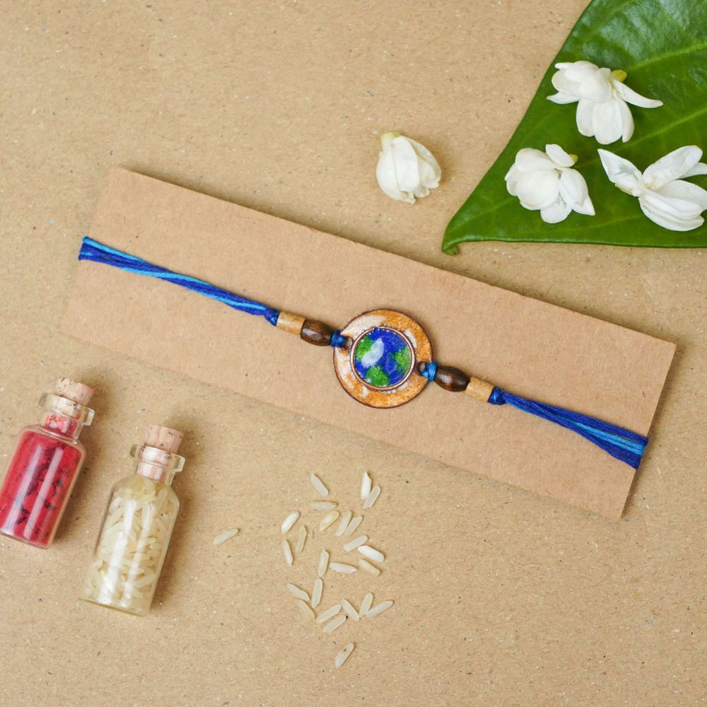Handmade Earthy Brown Copper Enamel Rakhi With Chocolates And Roli Chawal - Bracelet on gift card