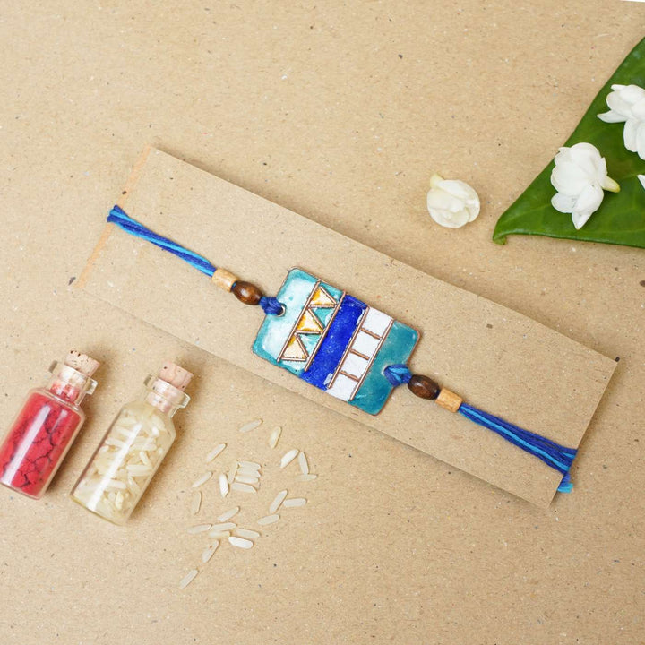 Handmade Zentangle Copper Enamel Rakhi With Chocolates And Roli Chawal - Bracelet on Rectangular Cardboard