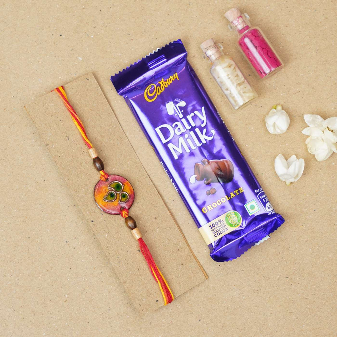 Handmade Morpankh Copper Enamel Rakhi With Chocolates And Roli Chawal - Red bracelet with chocolate gift set