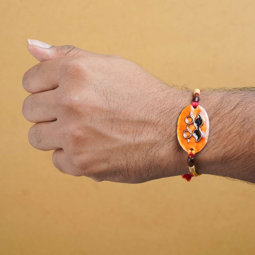 Handmade Mooch Copper Enamel Rakhi With Chocolates And Roli Chawal - Rakhi Styled on Wrist