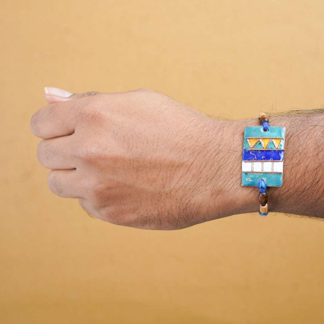 Handmade Zentangle Copper Enamel Rakhi With Chocolates And Roli Chawal - Worn on Wrist Display