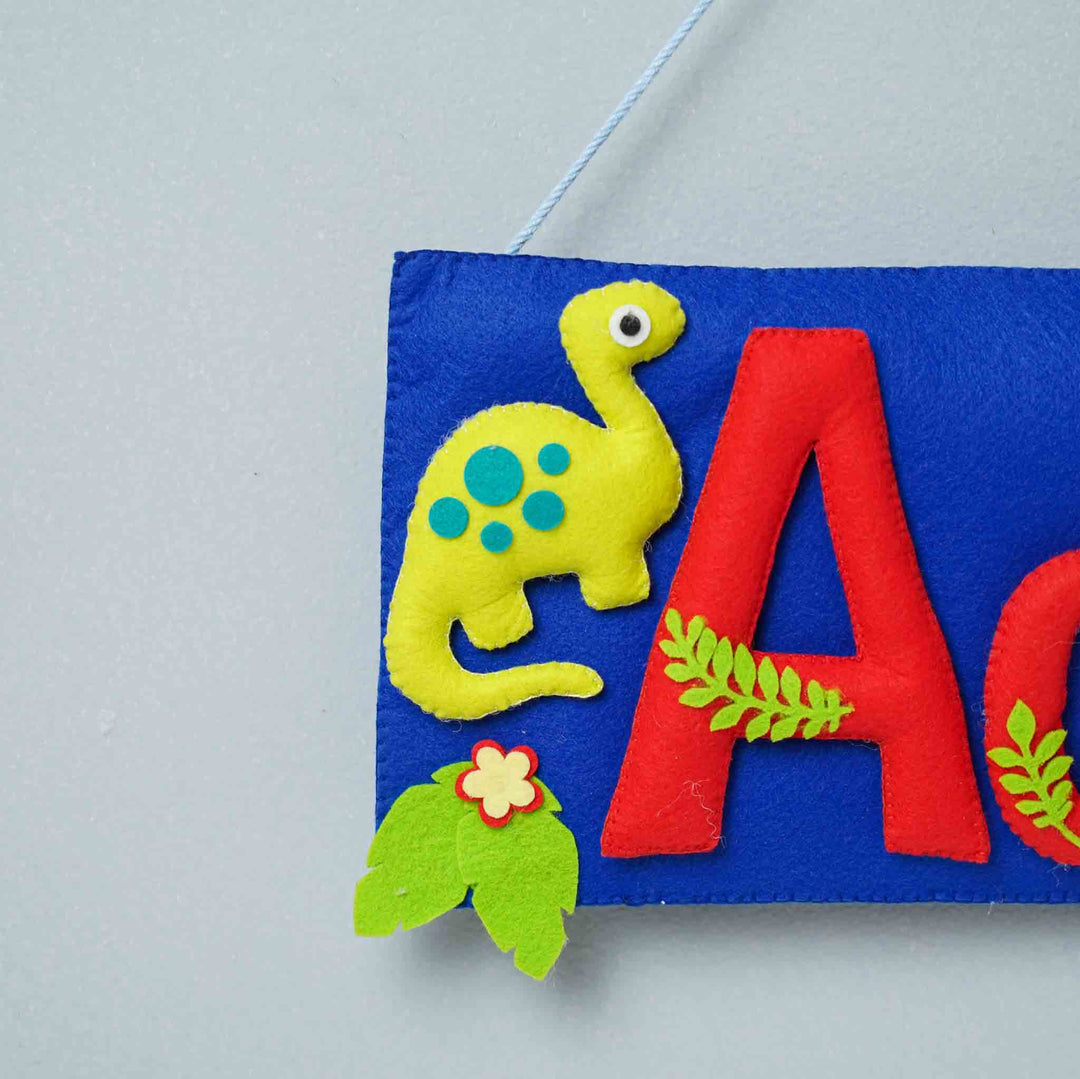 Handcrafted Dinosaur Themed Rectangle Felt Name Plate For Kids - Close-up of Hanging Plush Detail