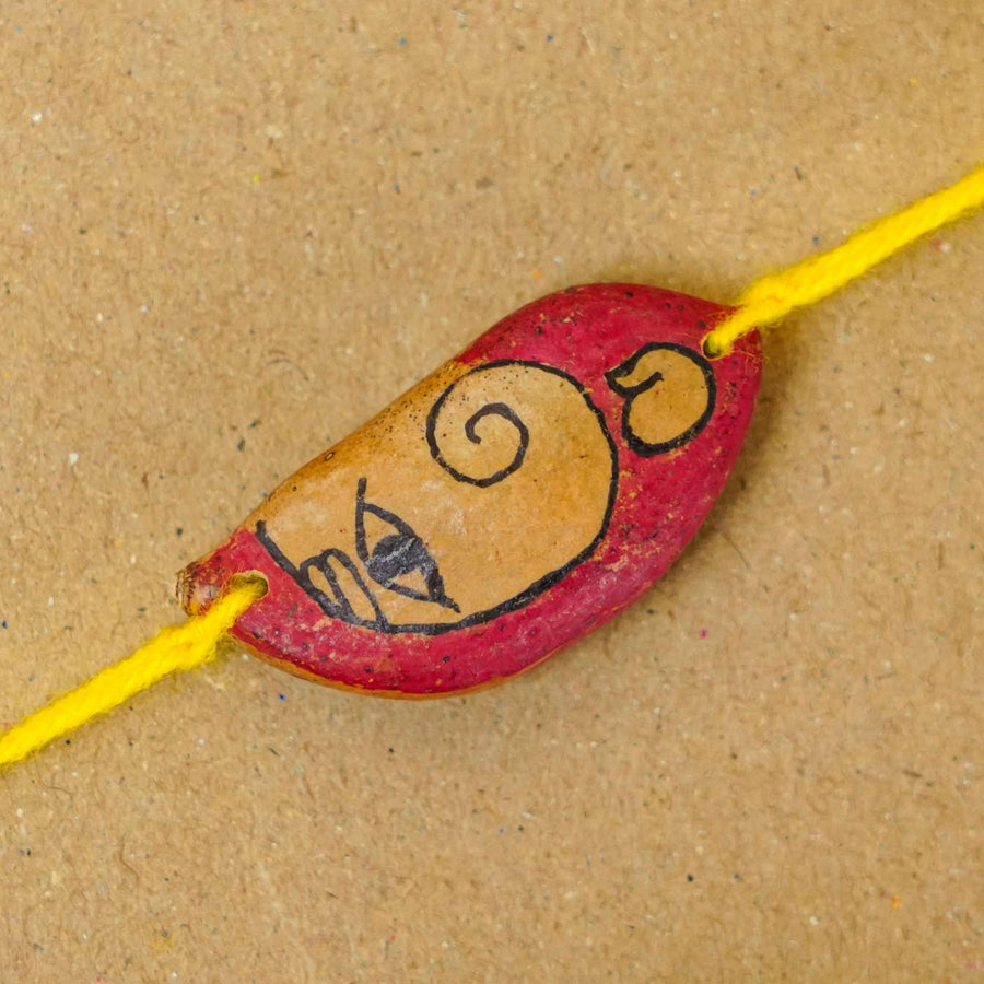 Handmade Plantable Ganesha Seed Rakhi With Roli Chawal - Close-up of bracelet bead