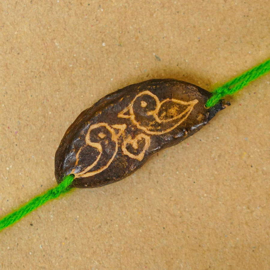 Handmade Plantable Green Birds Seed Rakhi With Roli Chawal - Close-up of designed seed bead