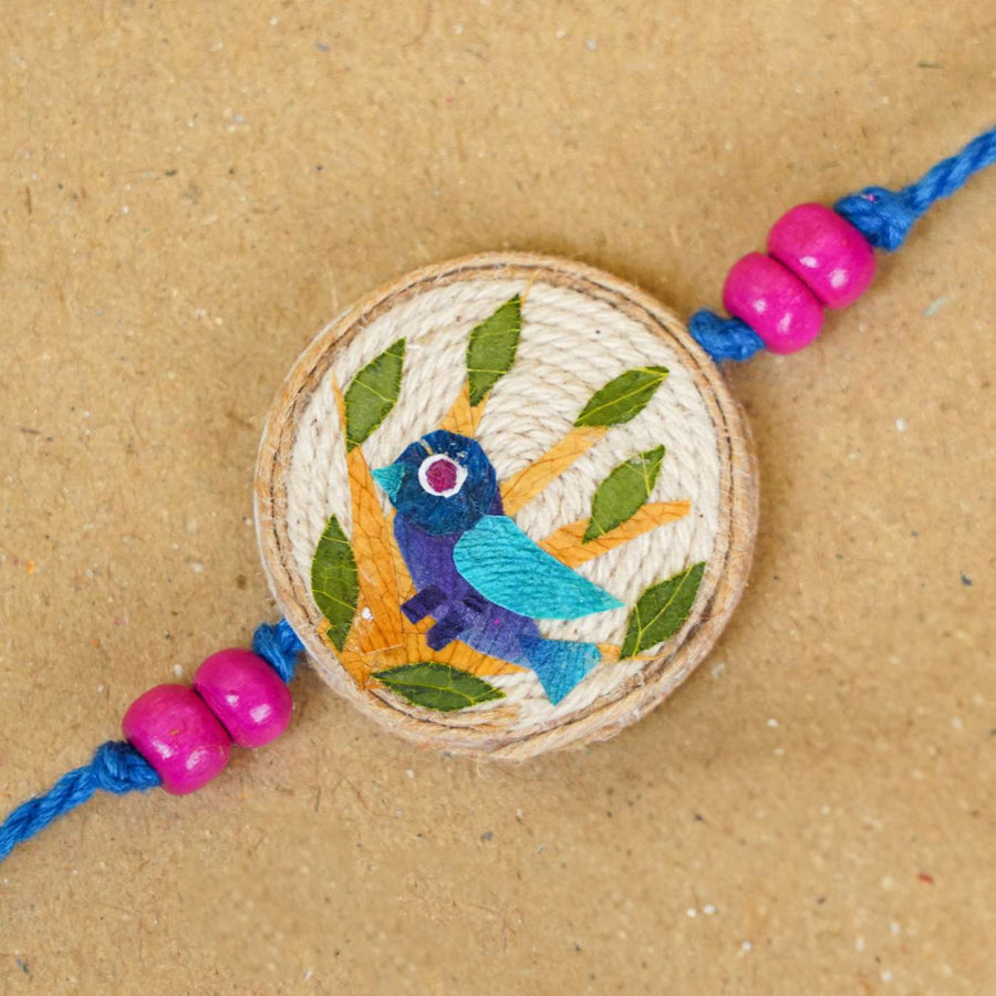Handmade Pressed Flower Art Bluebird Jute Rakhi With Roli Chawal - Close-up of Bird Design