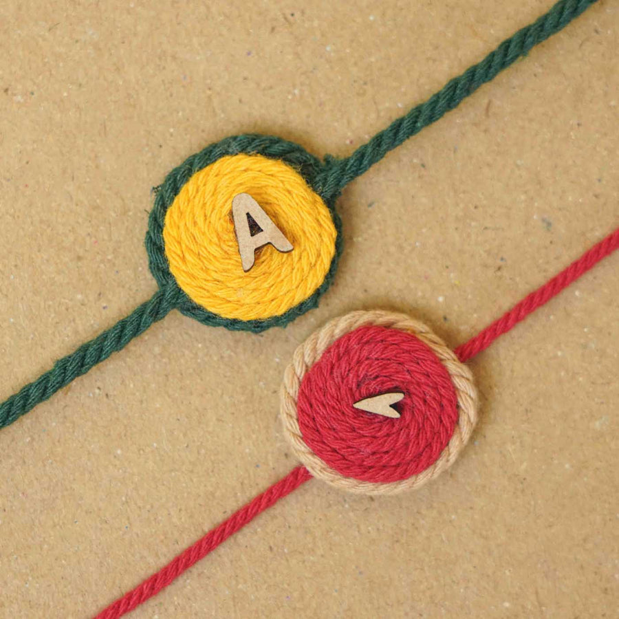 Personalized Handmade Alphabet Cotton Rakhi With Roli Chawal Set Of 2 - Close-up of Thread Embellishment