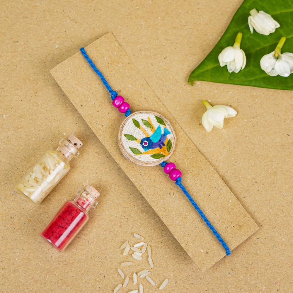 Handmade Pressed Flower Art Bluebird Jute Rakhi With Roli Chawal - Bracelet on Card Display
