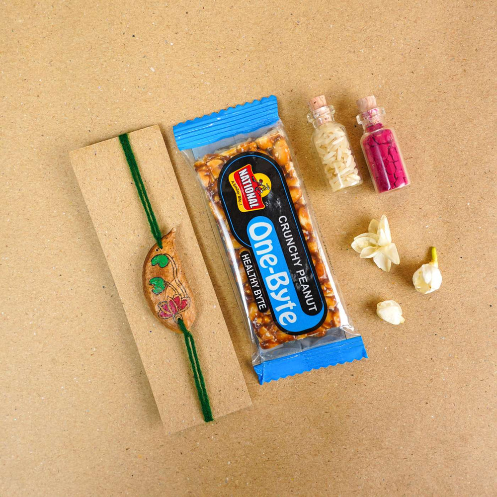 Handmade Plantable Magenta Lotus Seed Rakhi With Roli Chawal - Rakhi with snacks and packaging