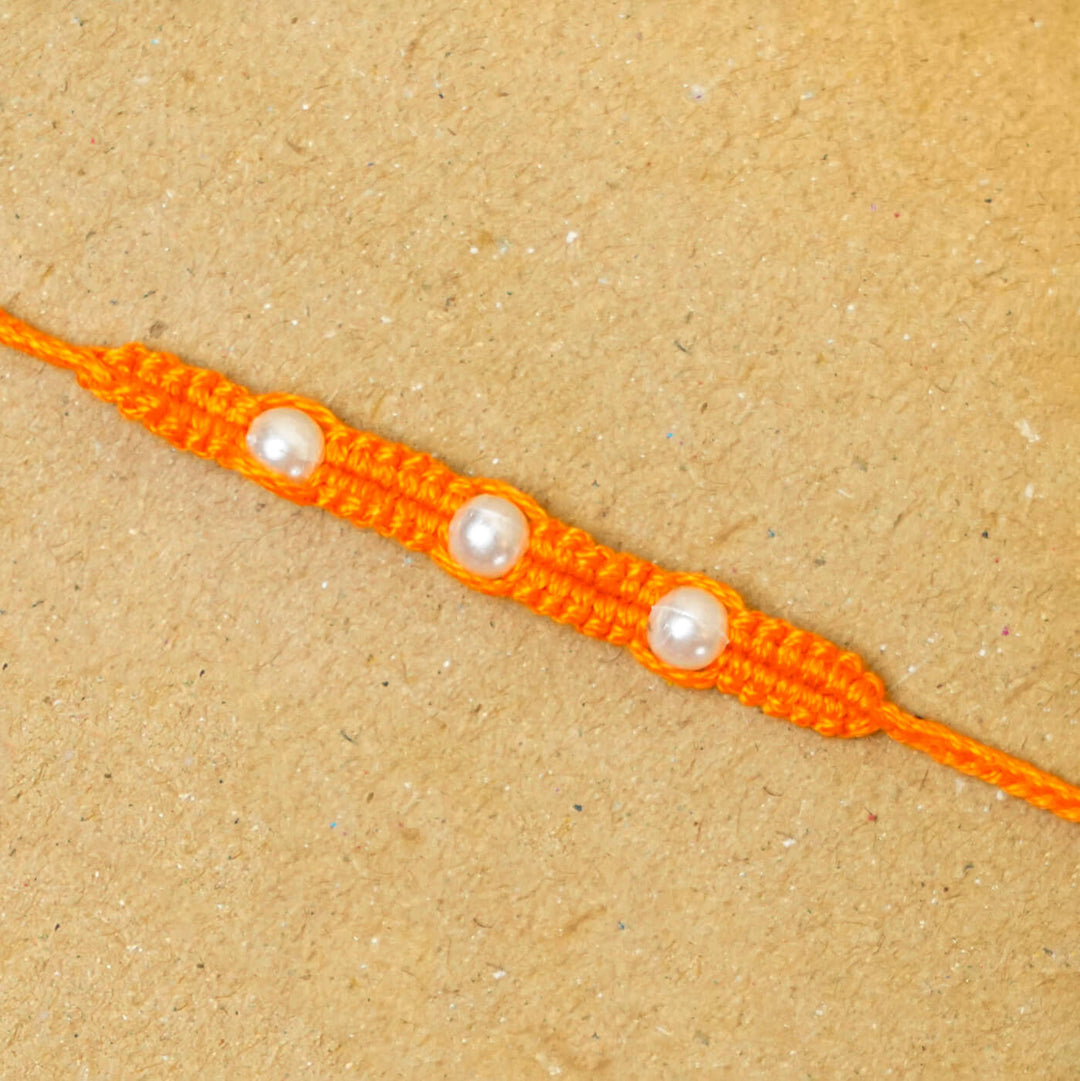 Handmade Macrame Three Pearl Rakhi With Roli Chawal - Close-up Front View (9)