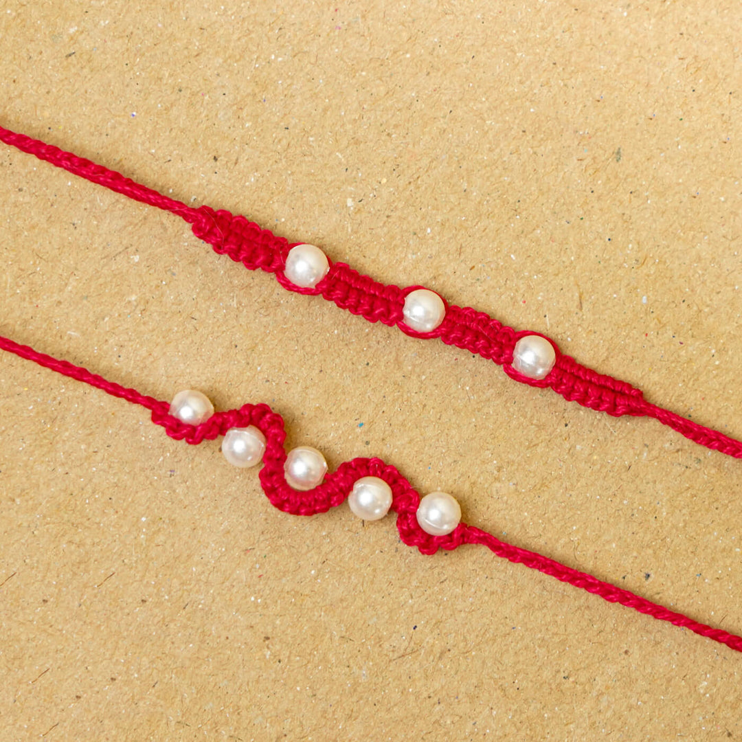 Handmade Macrame Beaded Rakhi With Roli Chawal Set Of 2 1 - Close-up of red rakhis