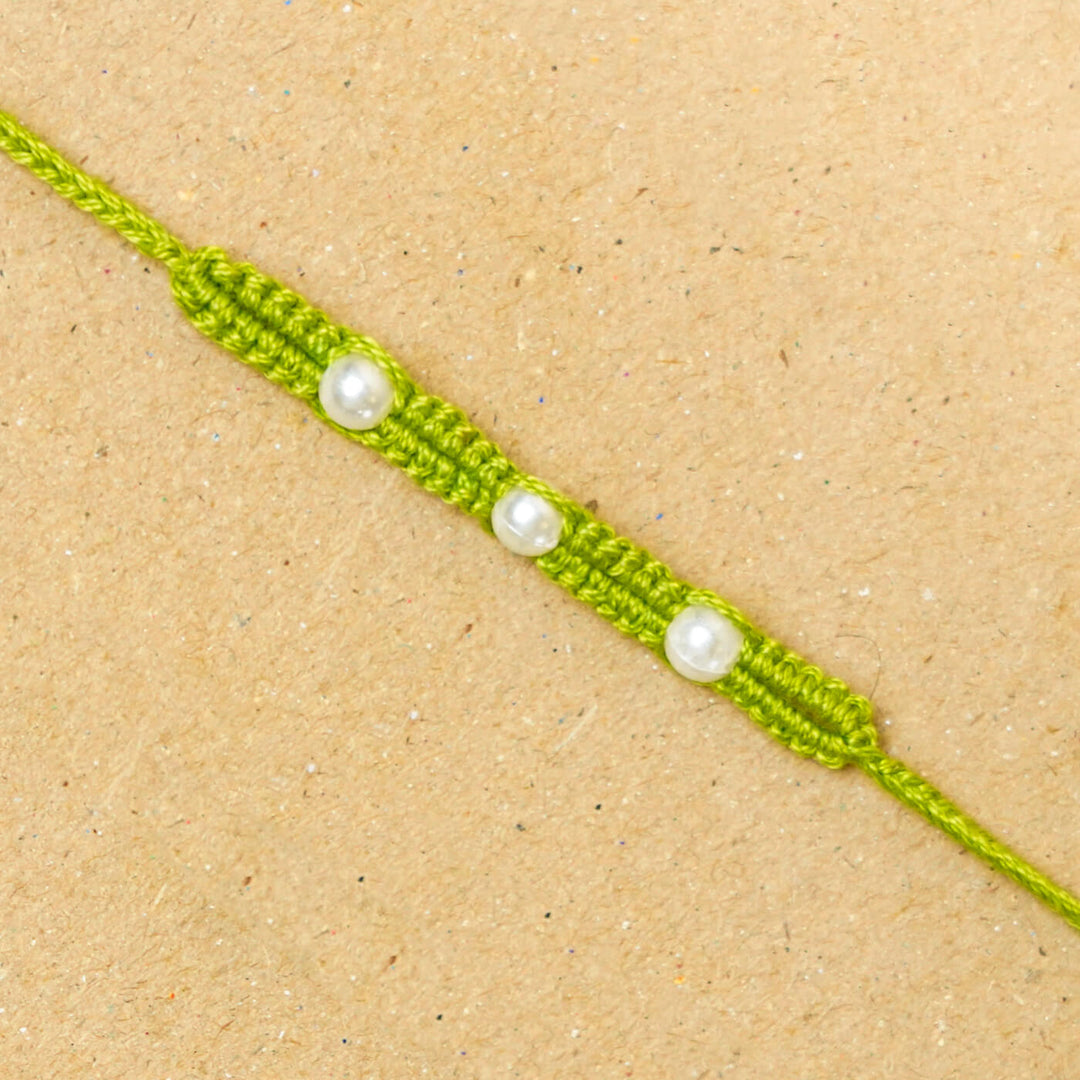 Handmade Macrame Three Pearl Rakhi With Roli Chawal - Close-up Front View