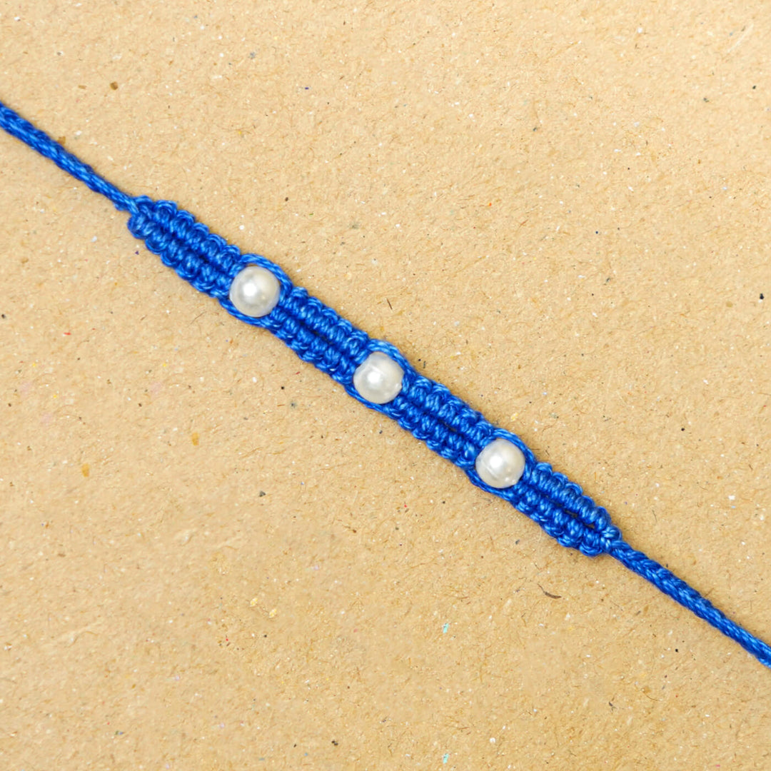 Handmade Macrame Three Pearl Rakhi With Roli Chawal - Close-up Front View (2)