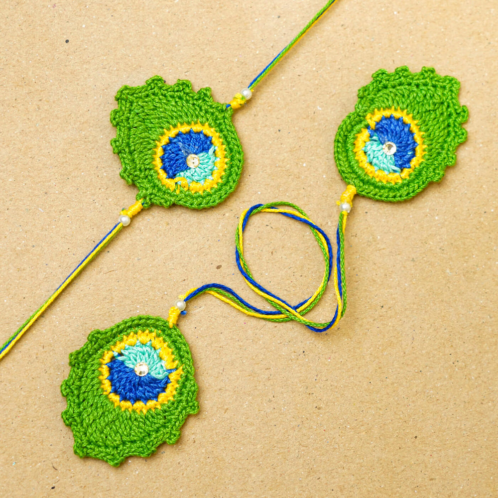 Handmade Crochet Peacock Feather Cotton Bhaiya Bhabhi Rakhi With Roli Chawal Set Of 2 - Flat lay showing full length