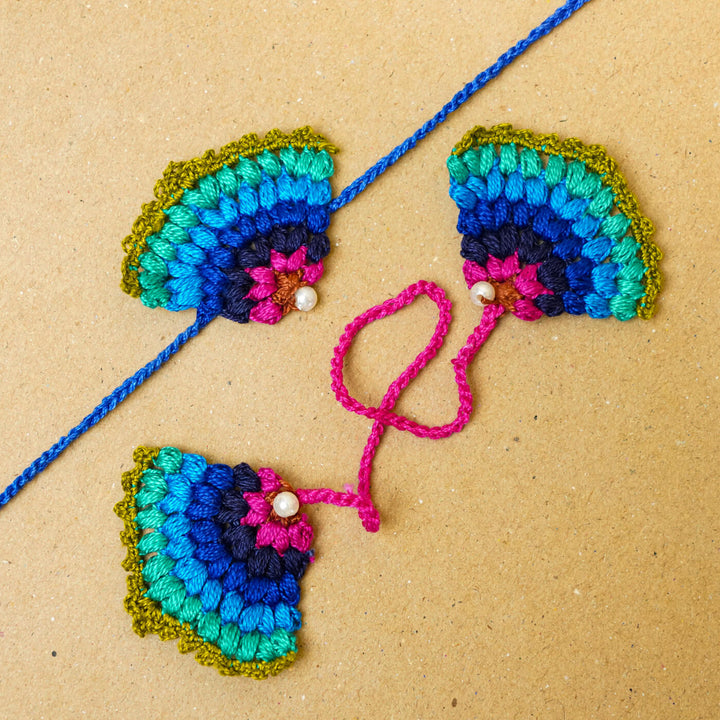 Handmade Crochet Peacock Cotton Bhaiya Bhabhi Rakhi With Roli Chawal Set Of 2 - Flat Lay Showing Strings