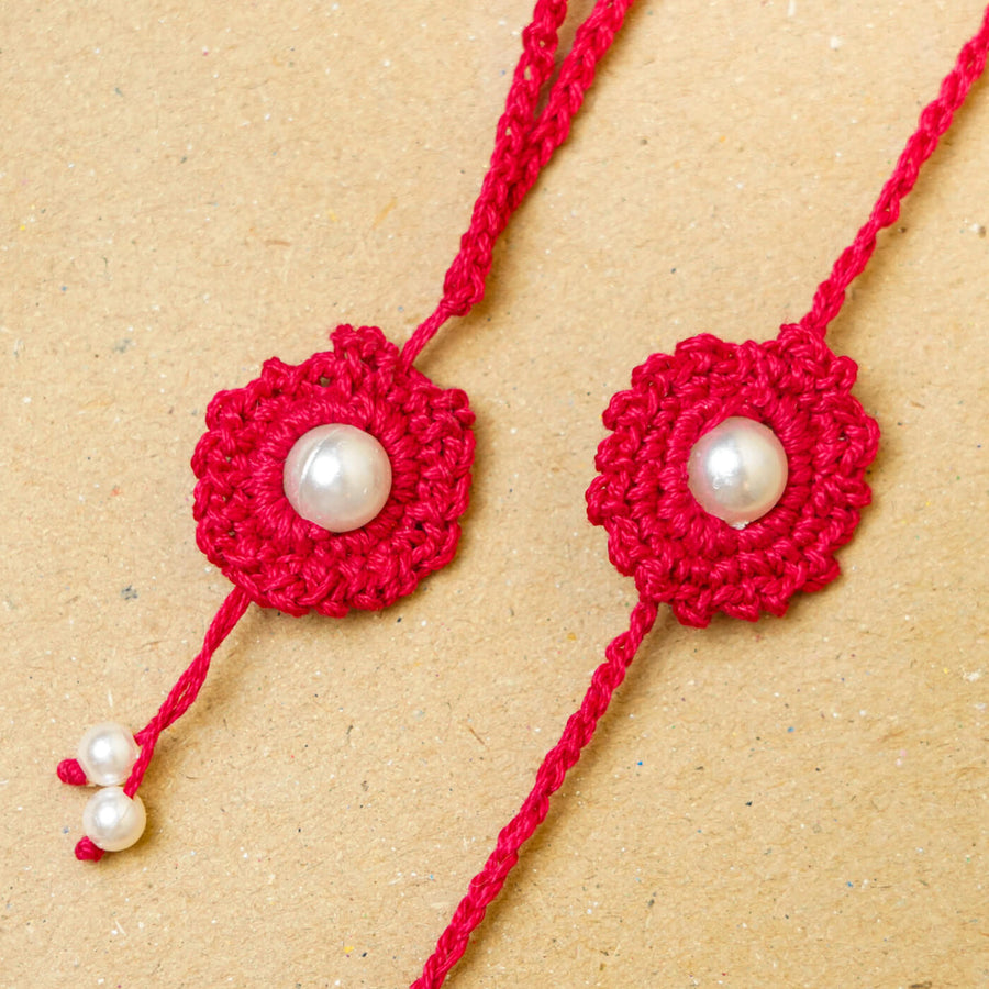 Handmade Crochet Round Pearl Cotton Bhaiya Bhabhi Rakhi With Roli Chawal Set Of 2 - Close-up of red rakhi pair