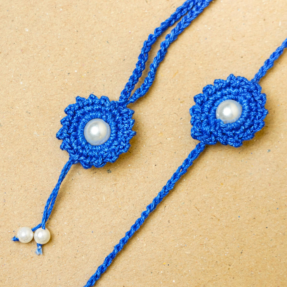Handmade Crochet Round Pearl Cotton Bhaiya Bhabhi Rakhi With Roli Chawal Set Of 2 - Close-up of blue rakhi pair