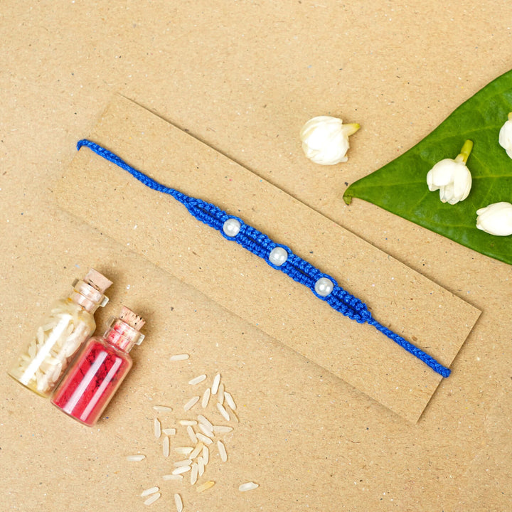 Handmade Macrame Three Pearl Rakhi With Roli Chawal - Flat Lay with Decorative Items