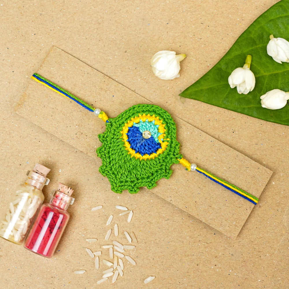 Handmade Crochet Peacock Feather Cotton Rakhi With Roli Chawal - Rakhi on Presentation Card with Decor