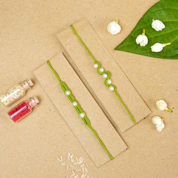 Handmade Macrame Beaded Rakhi With Roli Chawal Set Of 2 1 - Green rakhis on cardboard