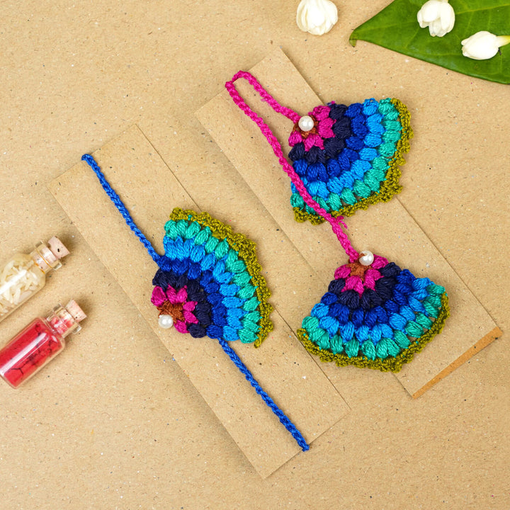 Handmade Crochet Peacock Cotton Bhaiya Bhabhi Rakhi With Roli Chawal Set Of 2 - Pair Displayed on Cardboard