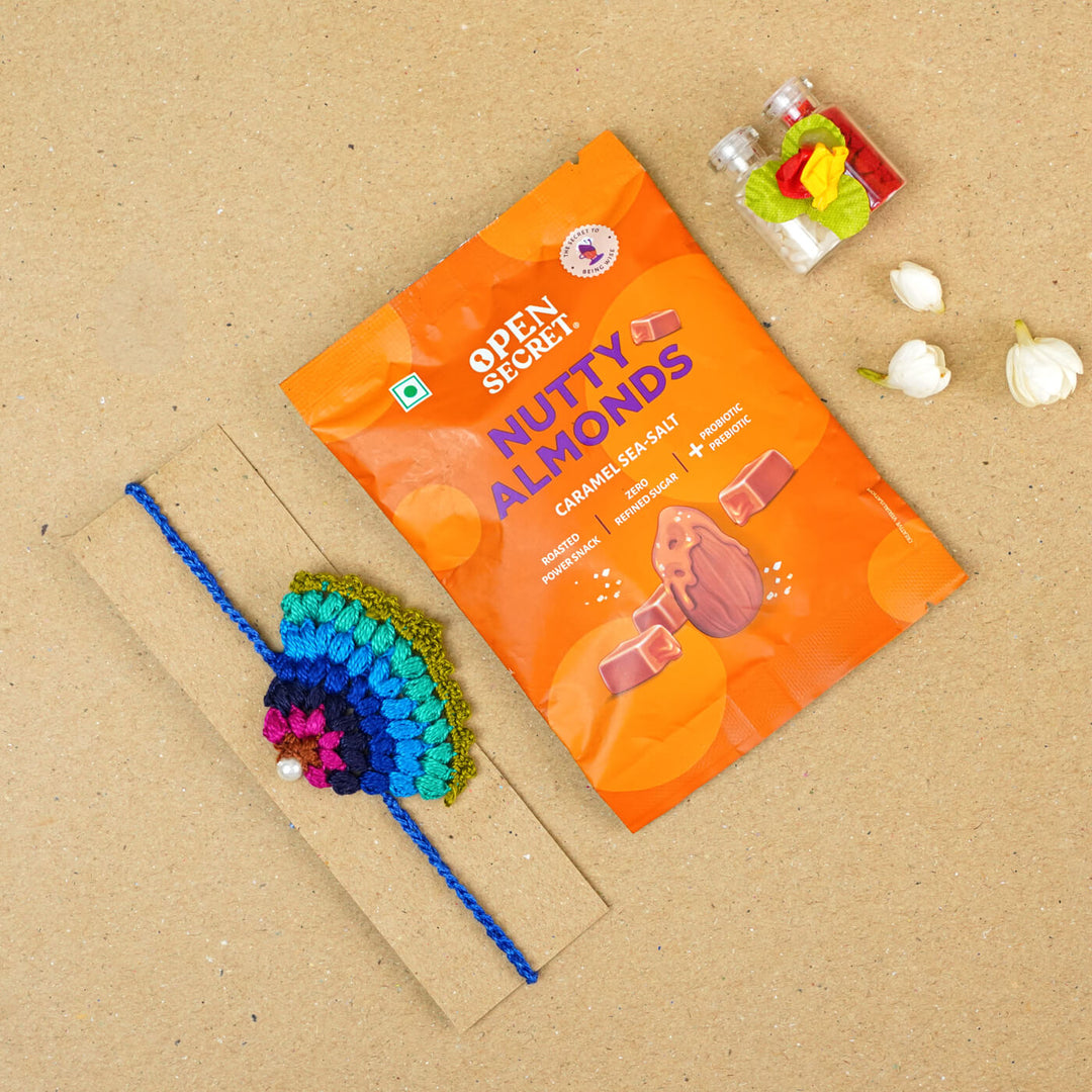 Handmade Crochet Peacock Cotton Rakhi With Roli Chawal - Size comparison with snack pack