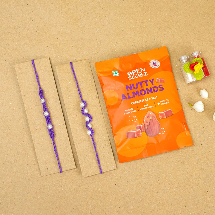 Handmade Macrame Beaded Rakhi With Roli Chawal Set Of 2 1 - Purple rakhis on cardboard