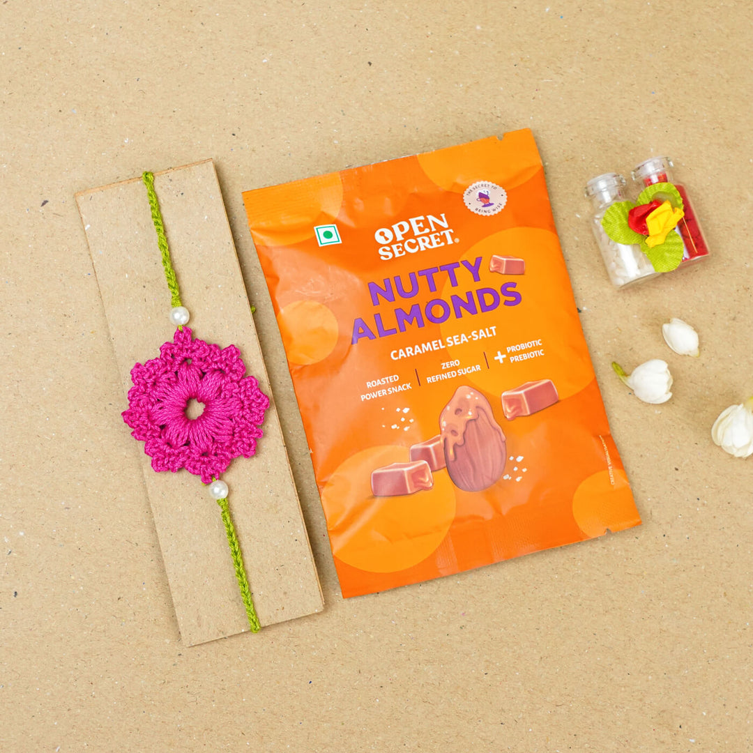 Handmade Crochet Floral Cotton Rakhi With Roli Chawal - Flat lay with snack pack (11)