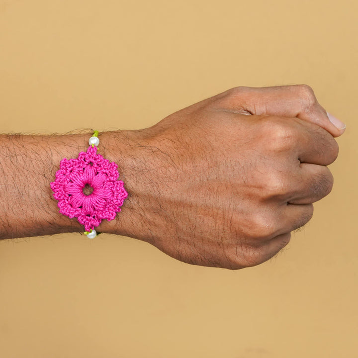 Handmade Crochet Floral Cotton Rakhi With Roli Chawal - Pink Rakhi worn on wrist