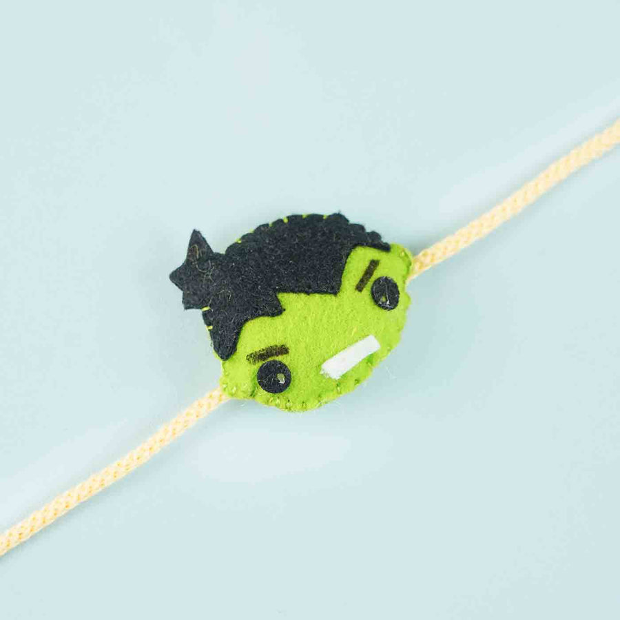 Handmade Hulk Felt Kids Rakhi With Roli Chawal - Close-up of Hulk face design