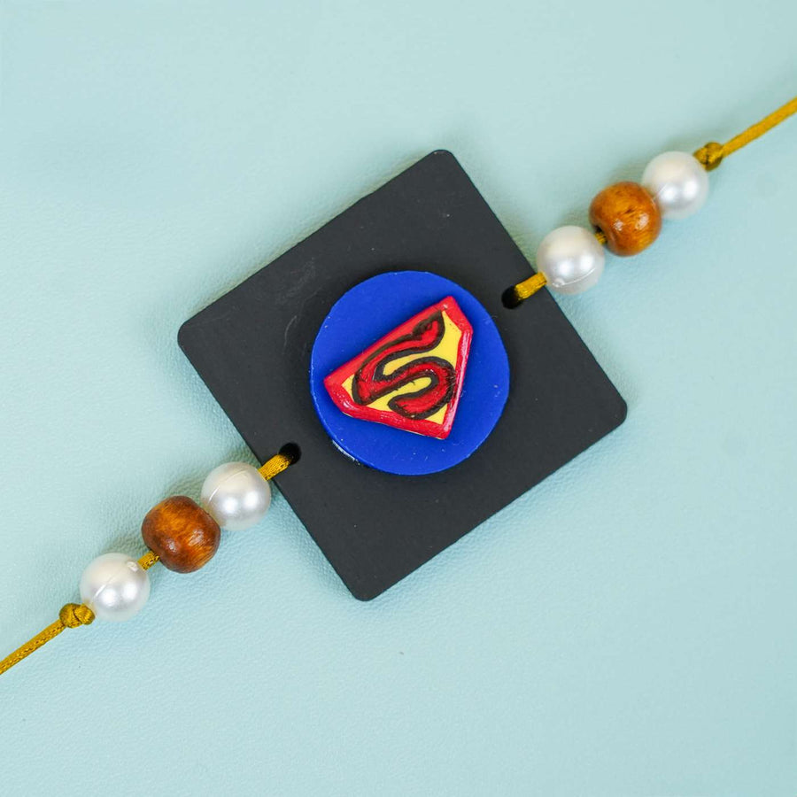 Handmade Miniature Clay Superman Kids Rakhi With Roli Chawal - Close-up of Single Rakhi Charm