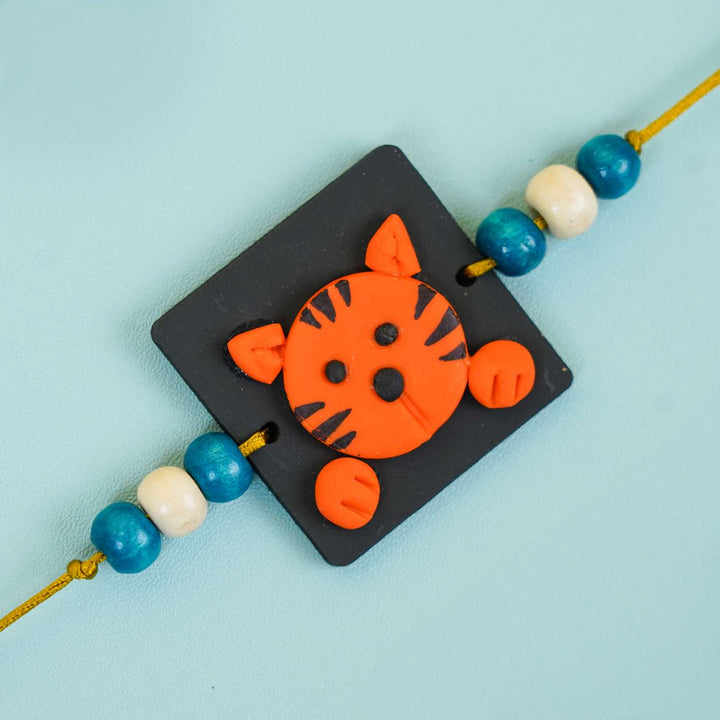 Handmade Miniature Clay Tiger Themed Kids Rakhi With Roli Chawal - Close-up of single bracelet charm