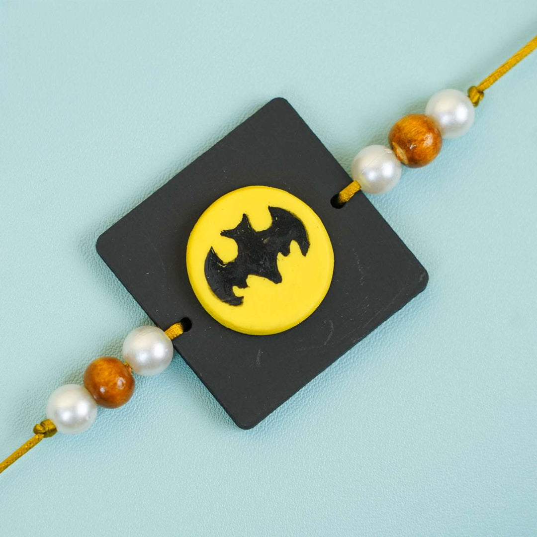Handmade Miniature Clay Batman Kids Rakhi With Roli Chawal - Close-up of Bracelet Charm