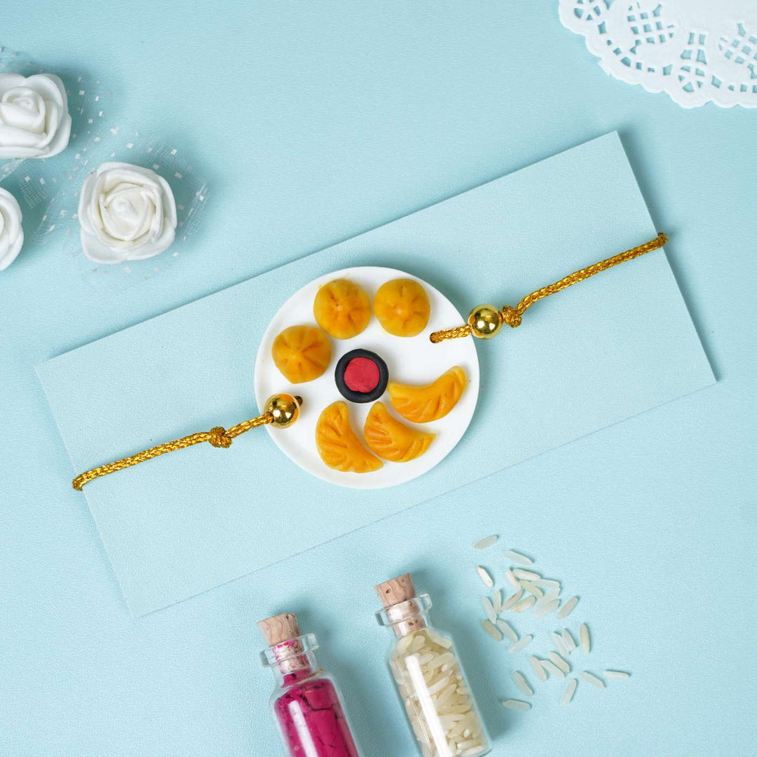 Handmade Miniature Clay Momos Rakhi With Roli Chawal - Styled with Decorative Props