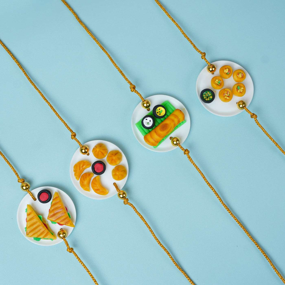 Handmade Miniature Clay Traditional Sweets Rakhi With Roli Chawal - Multiple Rakhi designs side by side