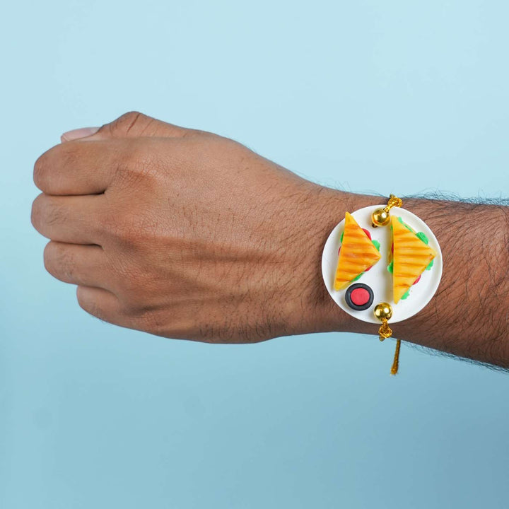 Handmade Miniature Clay Sandwich Rakhi With Roli Chawal - Worn on wrist model